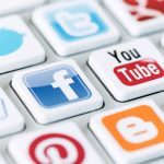 KIEV, UKRAINE - May 20, 2013: A social media logotype collection of well-known social network brand's printed on stickers and placed on modern computer keyboard.